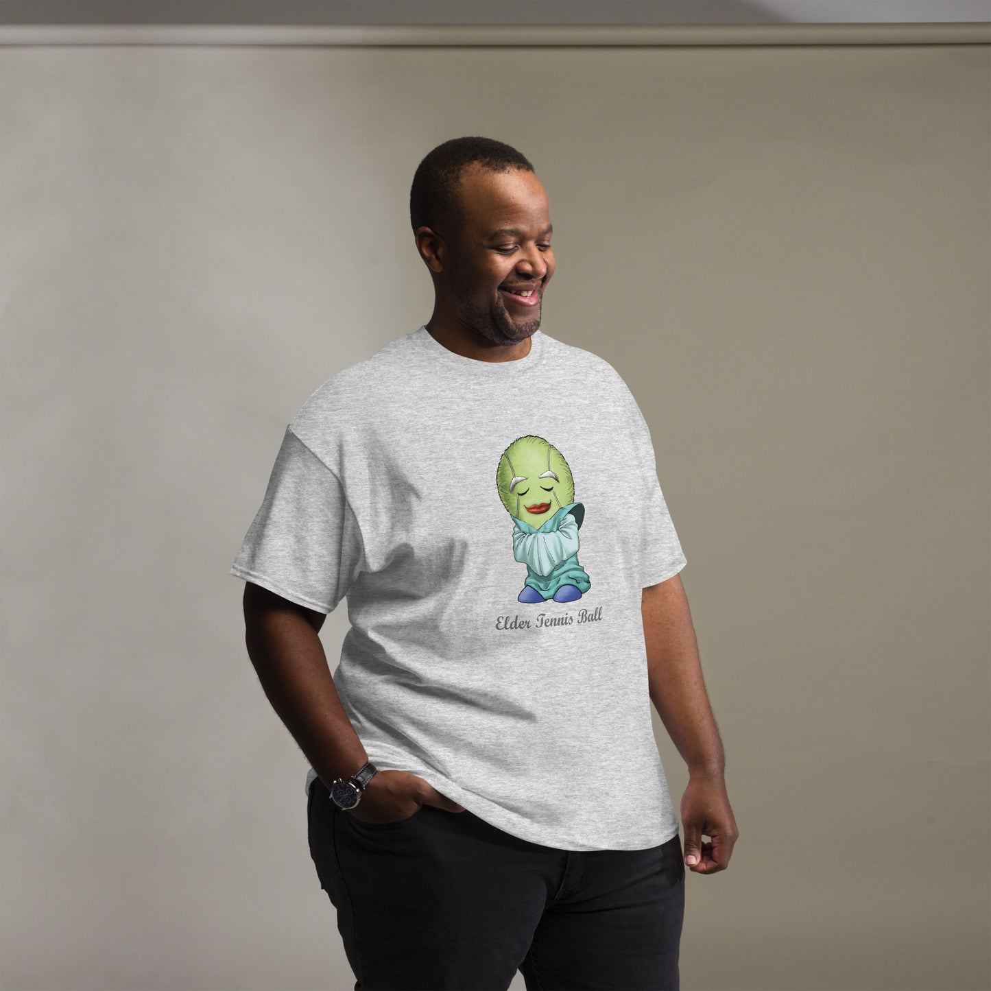 Man wearing a gray t-shirt with a Tennis Ball cartoon character print