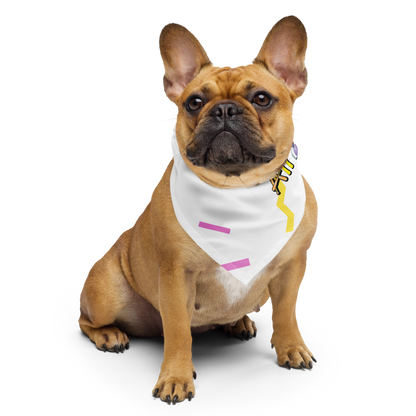 Brown dog wearing a white cutie l cotton bandana with colorful designs 