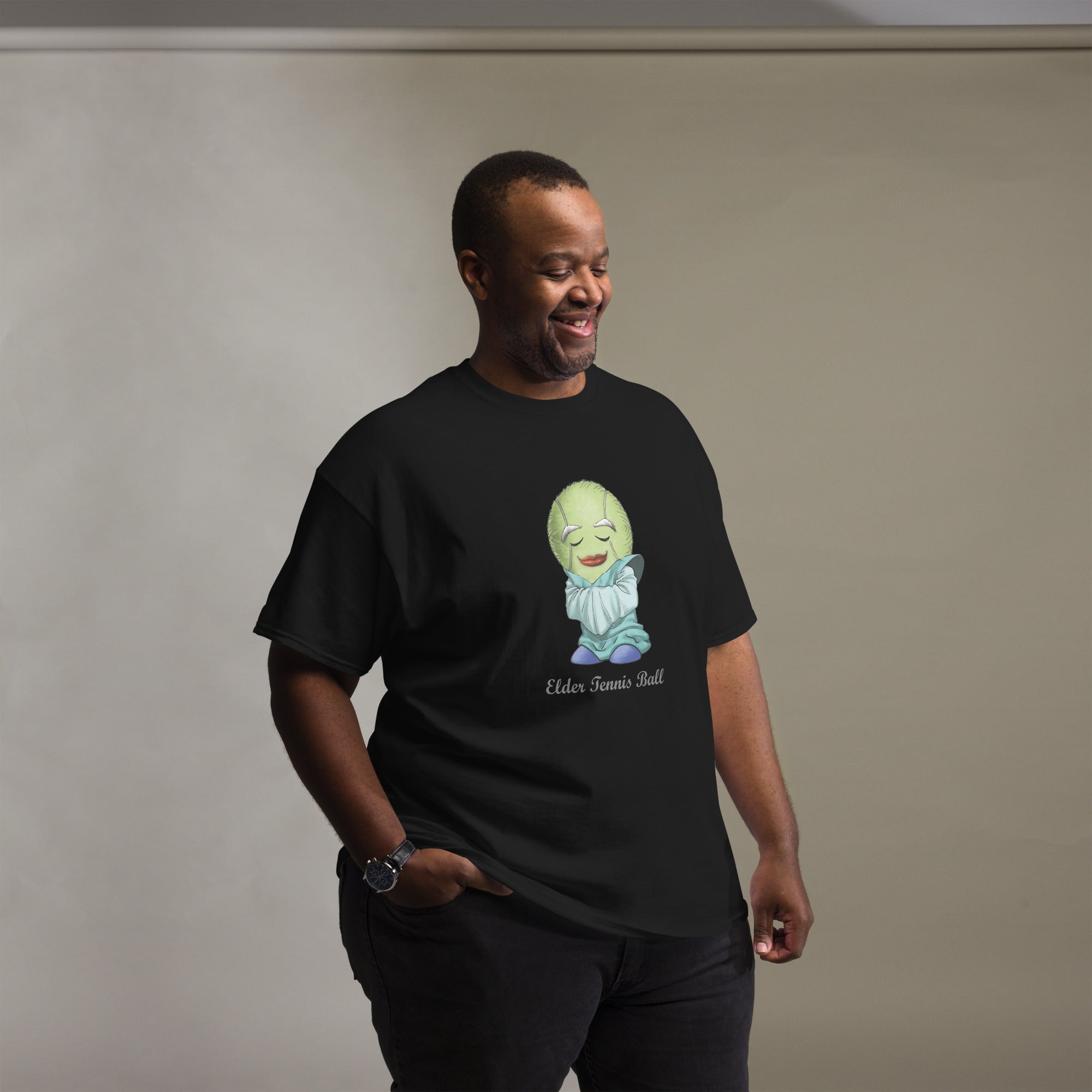 Man wearing a black t-shirt with a Tennis Ball cartoon character print 